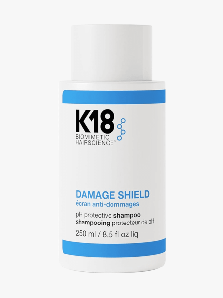 K18 Damage Shield pH Protective Shampoo in branded bottle component on a light gray background